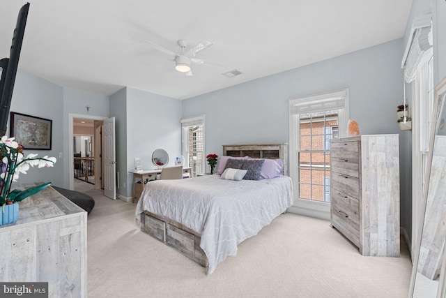 bedroom featuring light colored carpet, ceiling fan, and baseboards
