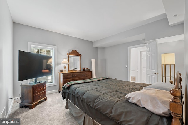 bedroom featuring carpet floors, baseboards, and multiple windows