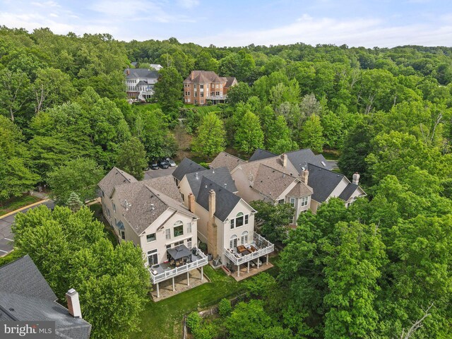 aerial perspective of suburban area featuring a heavily wooded area
