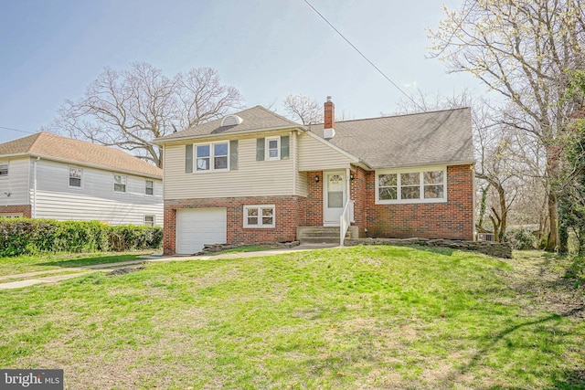 tri-level home featuring brick siding, a chimney, an attached garage, a front yard, and concrete driveway