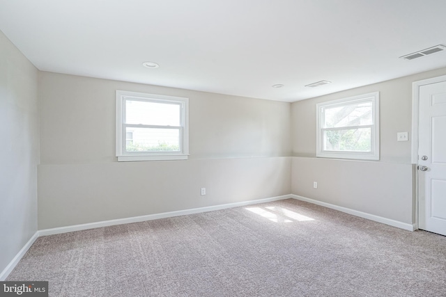 carpeted empty room with healthy amount of natural light and baseboards