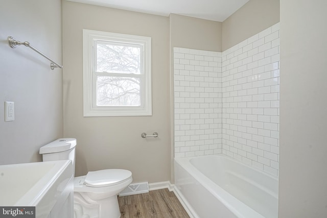 bathroom featuring toilet, baseboards, and wood finished floors