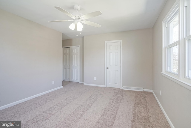 unfurnished bedroom with carpet flooring, baseboards, and a ceiling fan