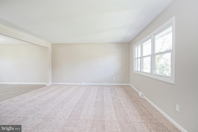 unfurnished room with baseboards and carpet flooring