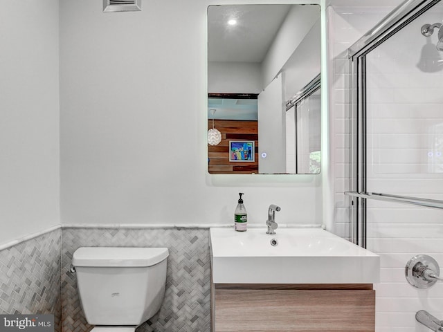 2025 Skyline Rd, Towson, MD 21204 - full bath with an enclosed shower, toilet, wainscoting, tile walls, and vanity