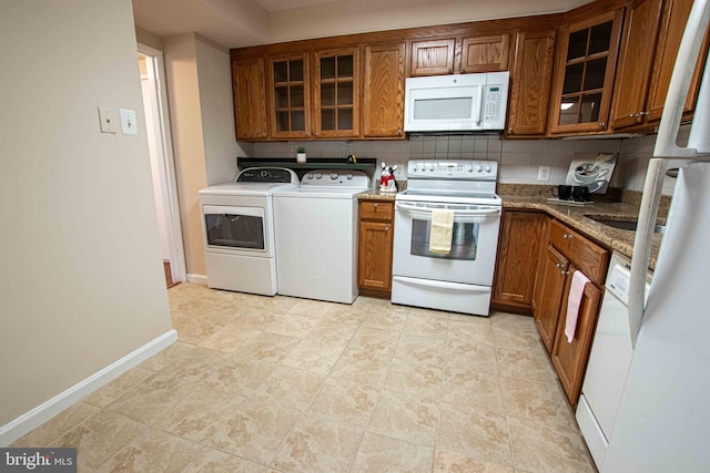 6301 Stevenson Ave Unit 602, Alexandria, VA 22304 - kitchen with white appliances, washer and clothes dryer, and brown cabinetry