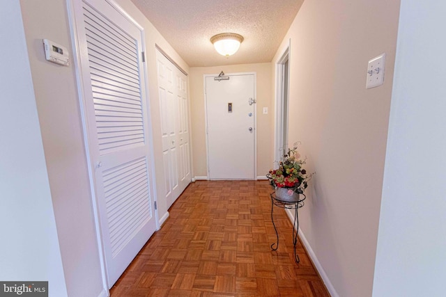 6301 Stevenson Ave Unit 602, Alexandria, VA 22304 - hallway featuring a textured ceiling and baseboards