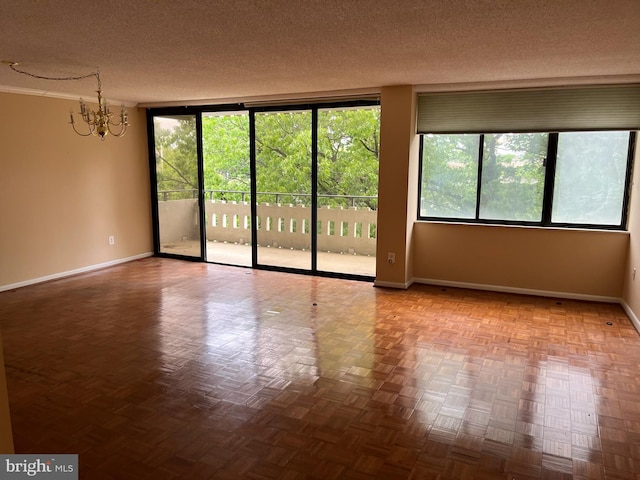 6301 Stevenson Ave Unit 602, Alexandria, VA 22304 - unfurnished room with a chandelier, baseboards, a textured ceiling, plenty of natural light, and floor to ceiling windows