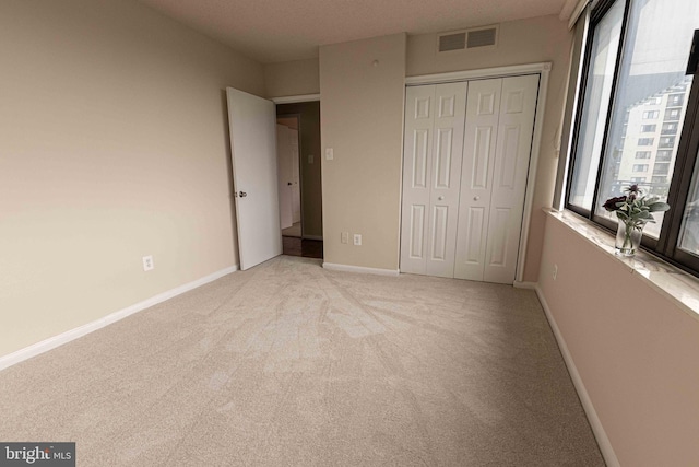 6301 Stevenson Ave Unit 602, Alexandria, VA 22304 - unfurnished bedroom featuring light colored carpet, a closet, and baseboards