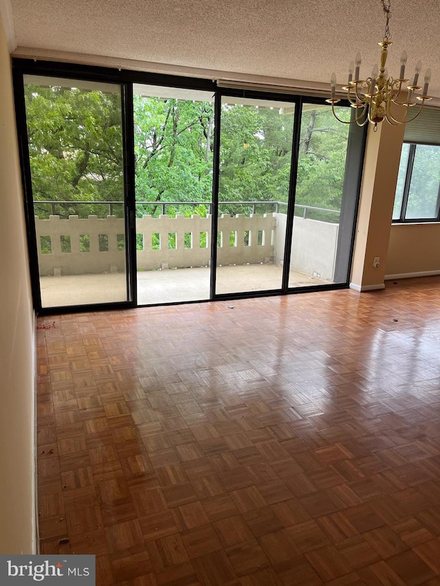 6301 Stevenson Ave Unit 602, Alexandria, VA 22304 - unfurnished room with a chandelier, a textured ceiling, and baseboards