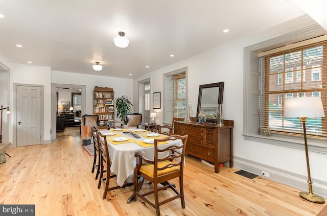 dining room featuring light wood-style floors, baseboards, and recessed lighting