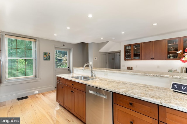 kitchen featuring dishwasher, a sink, light wood-style flooring, baseboards, and recessed lighting