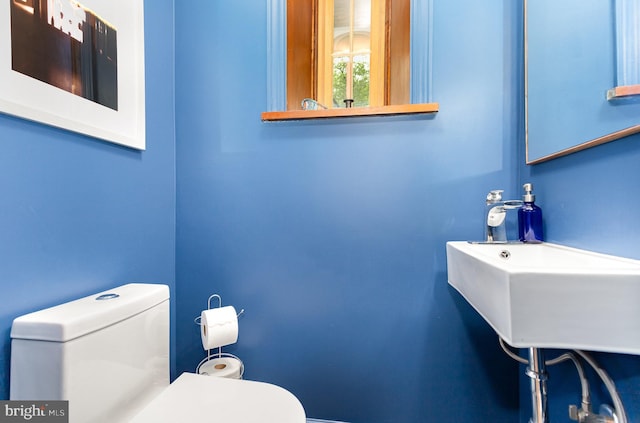 half bathroom featuring toilet