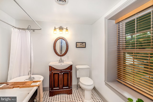 bathroom featuring baseboards, a bath, a shower with shower curtain, toilet, and vanity