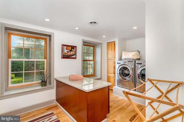 clothes washing area featuring separate washer and dryer, light wood-style flooring, recessed lighting, crown molding, and baseboards