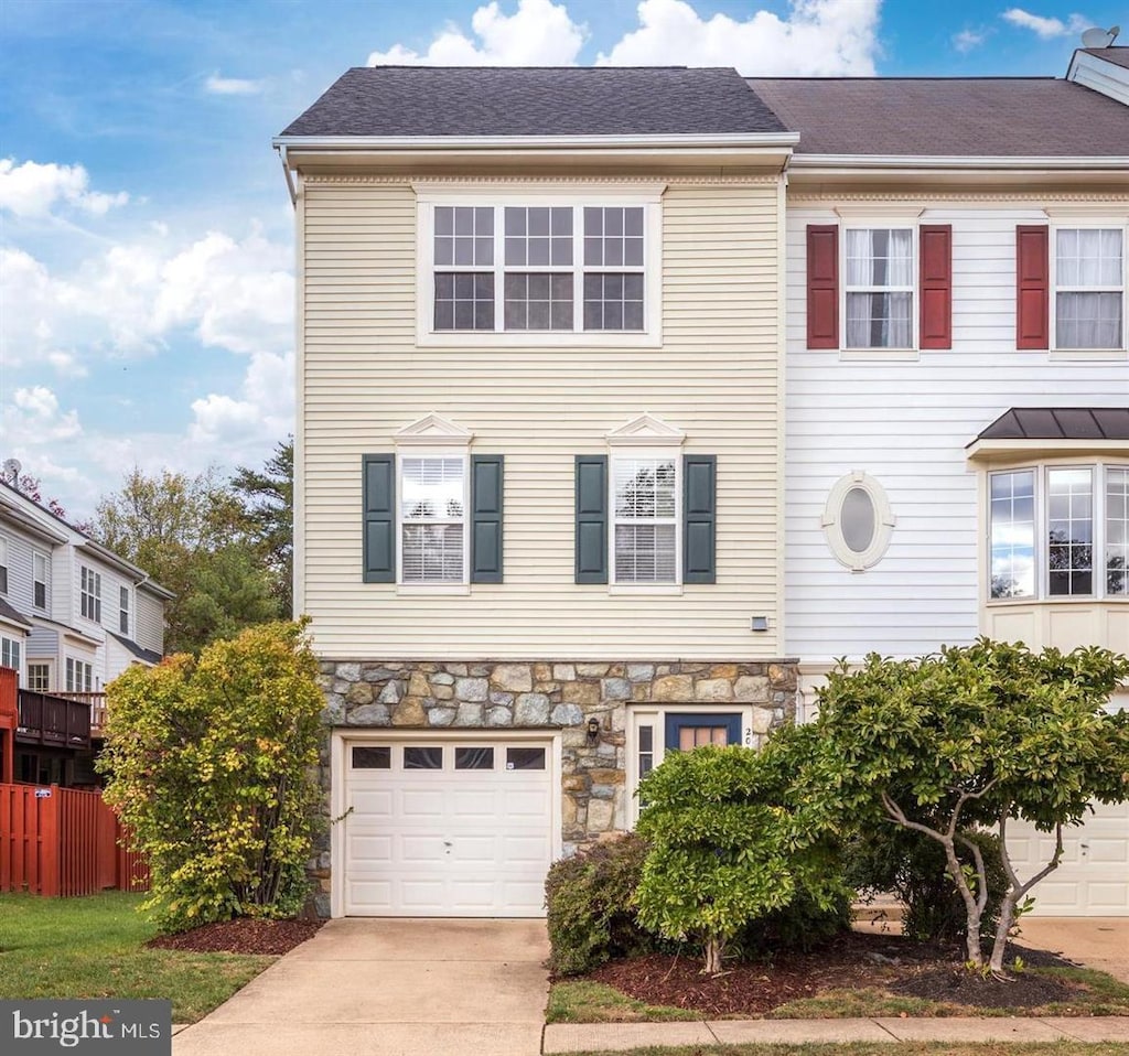 2015 Capstone Cir, Herndon, VA 20170 - townhome / multi-family property with stone siding, driveway, a garage, and fence