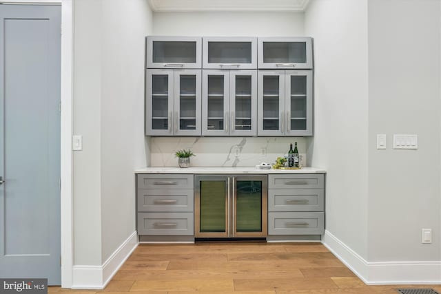 5706 Nevada Ave NW, Washington, DC 20015 - indoor bar featuring beverage cooler, light wood-type flooring, baseboards, and ornamental molding