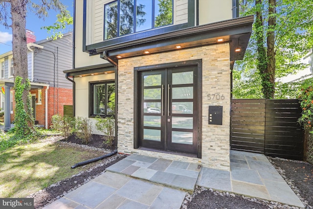 5706 Nevada Ave NW, Washington, DC 20015 - property entrance featuring french doors, fence, and stone siding