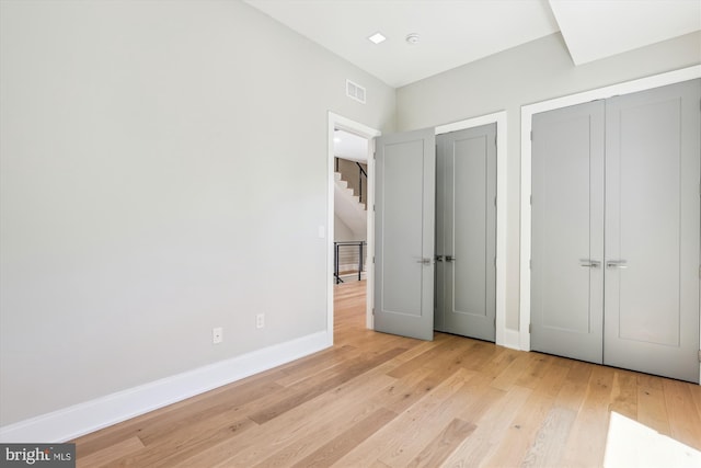 5706 Nevada Ave NW, Washington, DC 20015 - unfurnished bedroom featuring wood finished floors, baseboards, and two closets