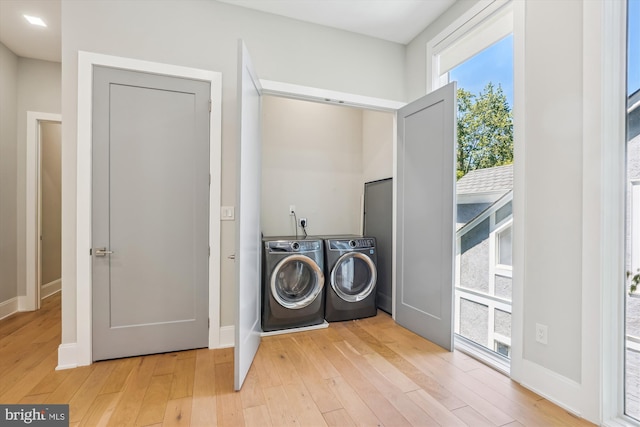 5706 Nevada Ave NW, Washington, DC 20015 - laundry area featuring washer and dryer, light wood-type flooring, and baseboards