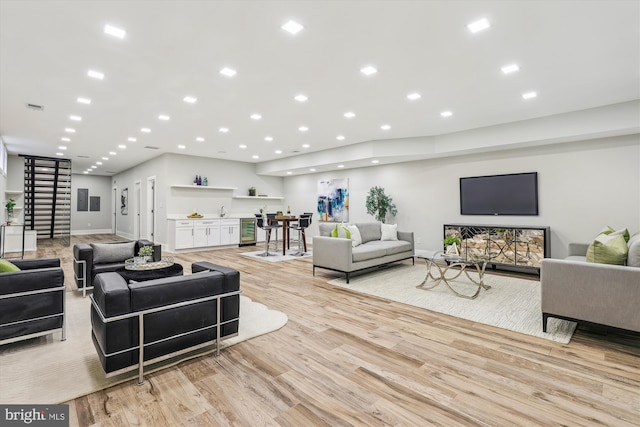 5706 Nevada Ave NW, Washington, DC 20015 - living area with light wood-style flooring, bar, recessed lighting, and baseboards