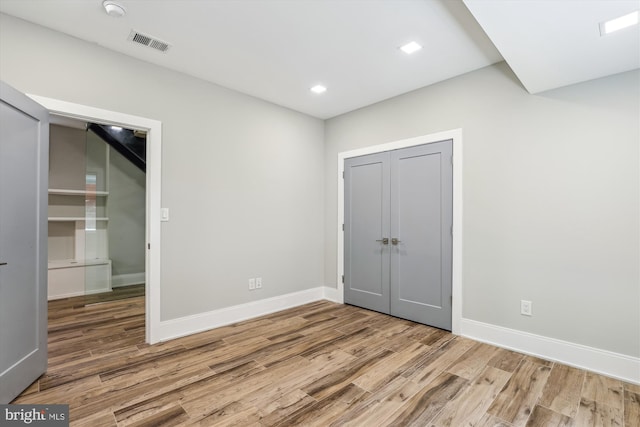 5706 Nevada Ave NW, Washington, DC 20015 - unfurnished bedroom with wood finished floors, baseboards, a closet, and recessed lighting