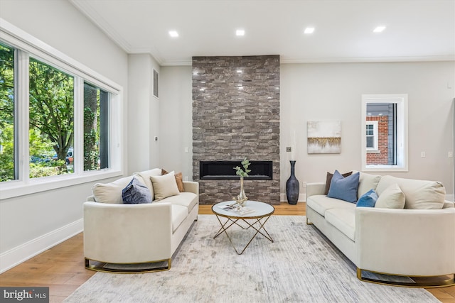 5706 Nevada Ave NW, Washington, DC 20015 - living area featuring wood finished floors, ornamental molding, a stone fireplace, baseboards, and recessed lighting
