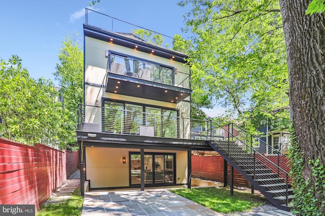 5706 Nevada Ave NW, Washington, DC 20015 - back of property featuring fence, stairs, a balcony, and a patio