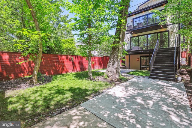 5706 Nevada Ave NW, Washington, DC 20015 - view of yard featuring stairs, a patio area, and a balcony