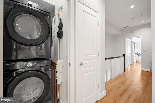 1407 15th St NW Unit 4, Washington, DC 20005 - laundry room featuring stacked washer / drying machine, light wood-style flooring, baseboards, and recessed lighting
