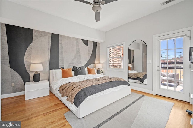 1407 15th St NW Unit 4, Washington, DC 20005 - bedroom with access to exterior, light wood finished floors, baseboards, and a ceiling fan