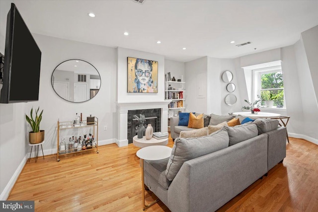 1407 15th St NW Unit 4, Washington, DC 20005 - living area with light wood finished floors, recessed lighting, a premium fireplace, and baseboards