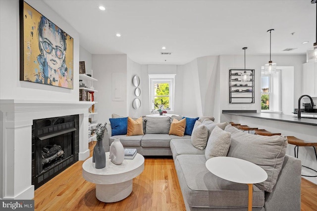 1407 15th St NW Unit 4, Washington, DC 20005 - living area featuring light wood-style floors, recessed lighting, and a fireplace