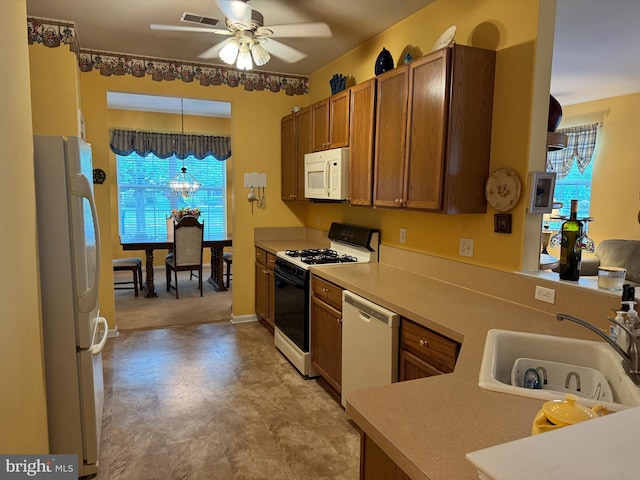 14 Pelican Ln, Tuckerton, NJ 08087 - kitchen featuring white appliances, a ceiling fan, a sink, brown cabinets, and decorative light fixtures