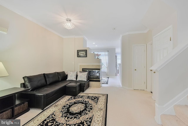 living area featuring a multi sided fireplace, carpet floors, crown molding, stairway, and baseboards