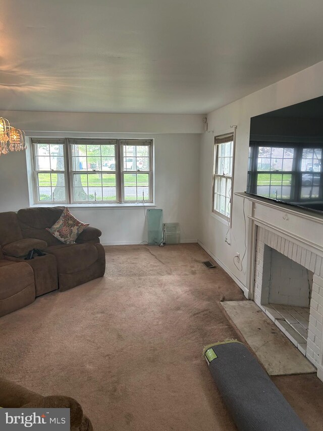 59 Emerald Ln, Willingboro, NJ 08046 - carpeted living area featuring a brick fireplace and baseboards
