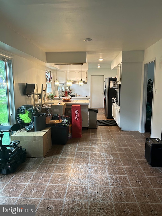 59 Emerald Ln, Willingboro, NJ 08046 - kitchen with appliances with stainless steel finishes, white cabinetry, hanging light fixtures, light countertops, and a peninsula
