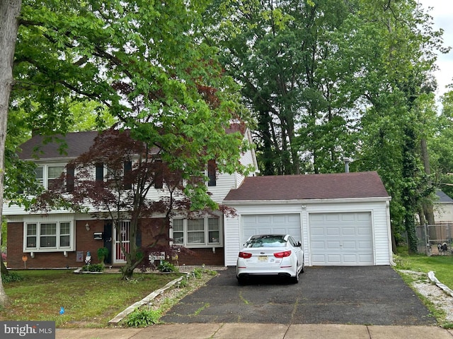 59 Emerald Ln, Willingboro, NJ 08046 - view of front of property featuring asphalt driveway, a garage, a front yard, and brick siding