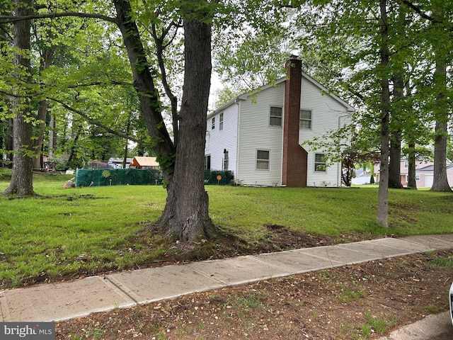 59 Emerald Ln, Willingboro, NJ 08046 - view of property exterior with a chimney and a lawn