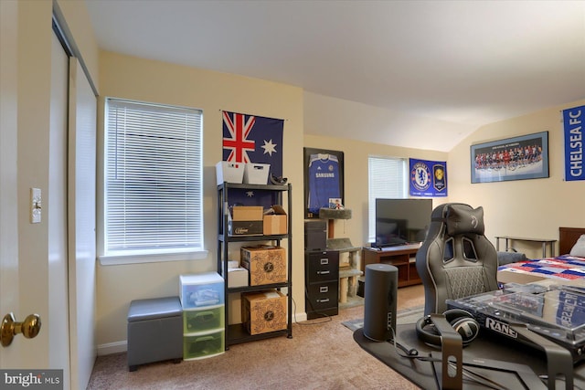 carpeted home office with lofted ceiling and baseboards