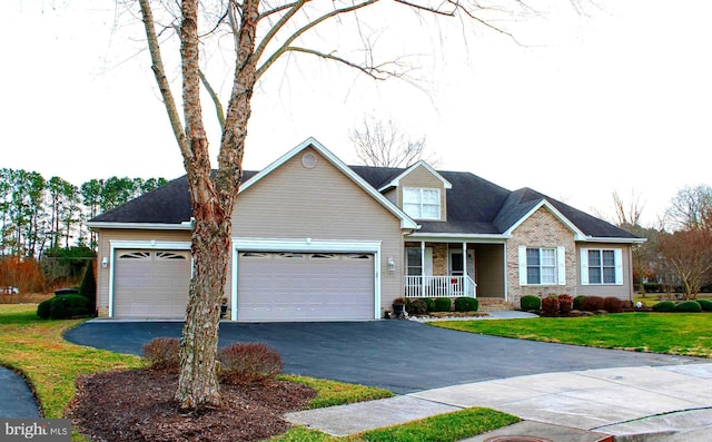 5951 Fire Fly Dr, Salisbury, MD 21801 - view of front of home with a porch, an attached garage, driveway, brick siding, and a front lawn