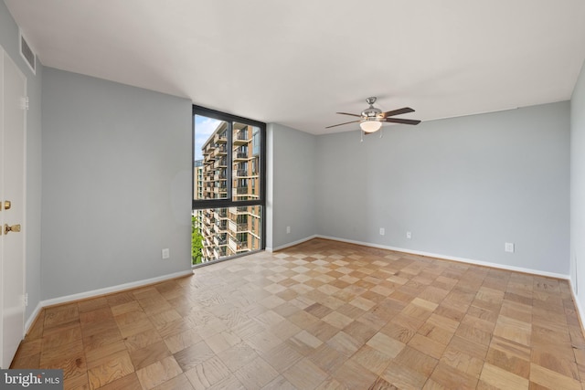 4620 N Park Ave N Unit 1206E, Chevy Chase, MD 20815 - spare room featuring ceiling fan, baseboards, and a wall of windows