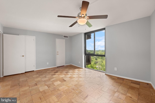 4620 N Park Ave N Unit 1206E, Chevy Chase, MD 20815 - empty room with ceiling fan, baseboards, and floor to ceiling windows