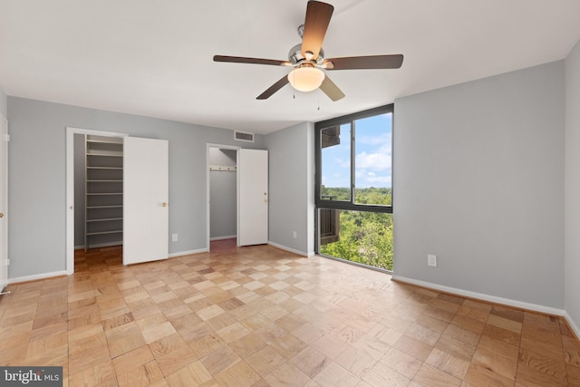 4620 N Park Ave N Unit 1206E, Chevy Chase, MD 20815 - unfurnished bedroom featuring baseboards, expansive windows, and ceiling fan