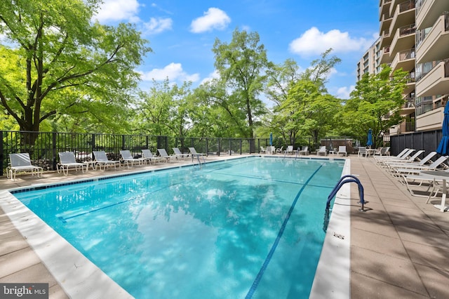 4620 N Park Ave N Unit 1206E, Chevy Chase, MD 20815 - community pool with a patio area and view of wooded area