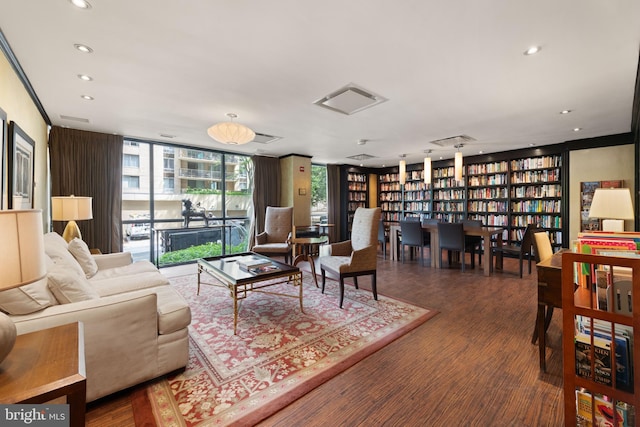 4620 N Park Ave N Unit 1206E, Chevy Chase, MD 20815 - living area with wood finished floors, floor to ceiling windows, recessed lighting, and wall of books