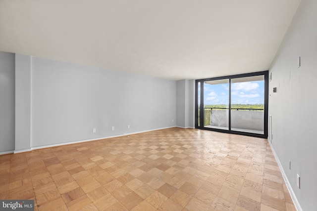 4620 N Park Ave N Unit 1206E, Chevy Chase, MD 20815 - spare room featuring floor to ceiling windows and baseboards