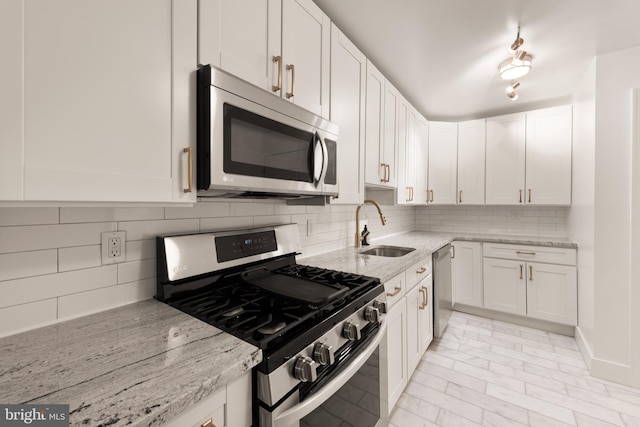 4620 N Park Ave N Unit 1206E, Chevy Chase, MD 20815 - kitchen with stainless steel appliances, a sink, white cabinets, and tasteful backsplash