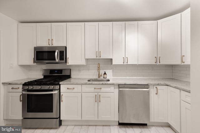4620 N Park Ave N Unit 1206E, Chevy Chase, MD 20815 - kitchen with stainless steel appliances, a sink, white cabinets, and backsplash