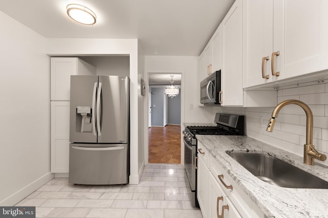 4620 N Park Ave N Unit 1206E, Chevy Chase, MD 20815 - kitchen with appliances with stainless steel finishes, a sink, backsplash, and white cabinets